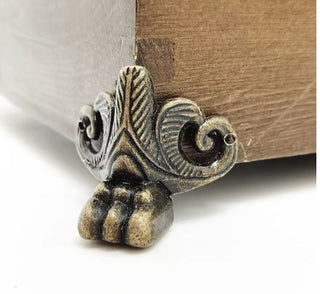 Decorative metal foot on a wooden surface