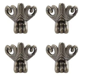 Four decorative metal brackets with intricate designs on a white background