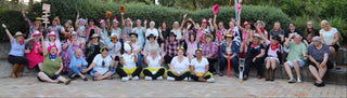 Group of people posing for a photo outdoors with trees in the background