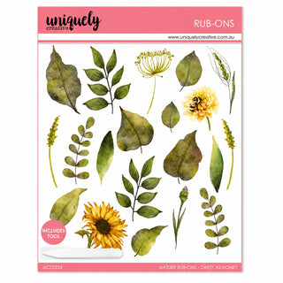 A sheet of watercolor-style botanical rubber stamps from Uniquely Creative, featuring green leaves, yellow flowers, and sunflowers on a white background with a pink border.