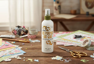 All-purpose art glue bottle on a table with craft supplies